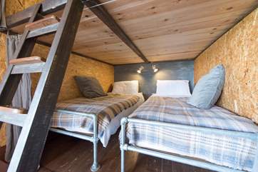 The comfortable twin beds with their lovely linens and woollen throws.