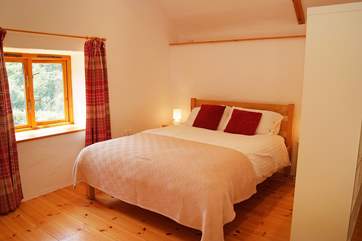 The bedroom is furnished with a five foot king-size bed.