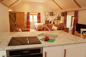The open plan living-room as seen from the kitchen at one end of the barn.