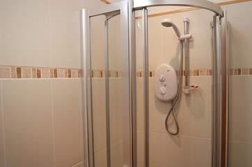The shower-room has a large cubicle.