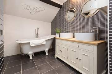 The family bathroom has a wonderful slipper bath as well as a separate shower.