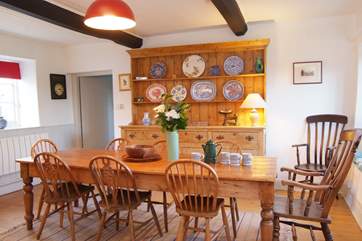 The dining room has an antique farmhouse dining table and dresser to add authentic character to this lovely room.