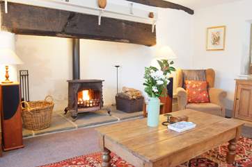 The living room has a huge fireplace with a vintage French wood burning stove.