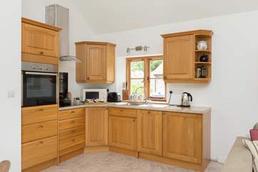 The kitchen is fitted around the corner of the open plan living space.