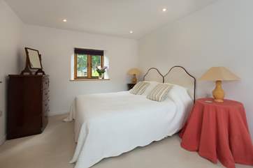 The bedroom has a wonderful king-sized bed and plenty of space for storage too.