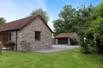 There is plenty of parking and your own drive entrance. The garage is extra space for you to use, and houses some of the domestic equipment.