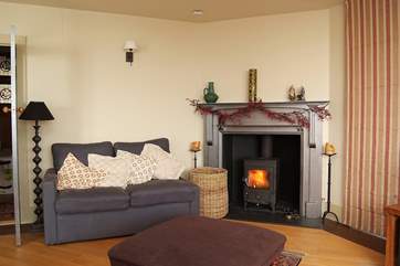 The sitting-area has a roaring wood-burner.
