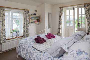 The double bedroom is gorgeous, a wonderful comfortable bed, a Juliet balcony and views right across the rooftops and the countryside beyond.