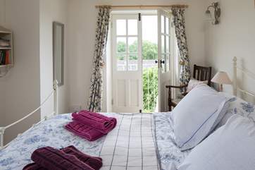 Beautiful linens add to the charm of this pretty bedroom.
