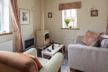 A wood-burner is tucked into one corner of the living area.