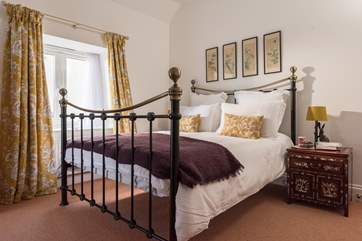 The lovely double bedroom with large metal bed.