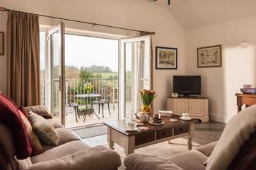 French doors open onto the balcony bringing the outside in and making the most of the wonderful views.