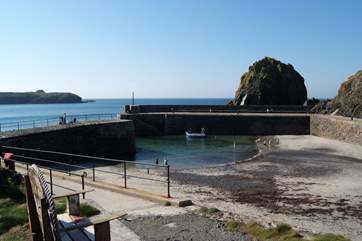 The picturesque harbour has a sandy beach at low tide.