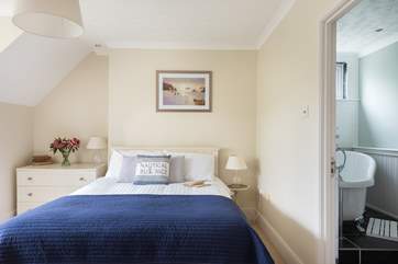 This lovely bedroom has a gorgeous en suite bathroom and a walk in closet.