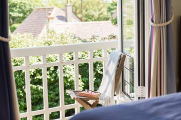 Choose a book from the library and take a seat on the balcony.