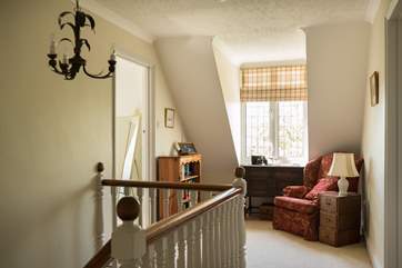 The large open landing with doors leading to all bedrooms and a cosy corner to take a moment or two.