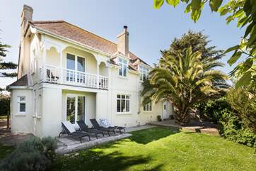 Tregwyth is a majestic looking house surrounded by gardens (a view of the rear of the house).