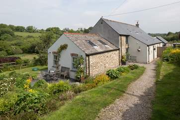 There is a path down from the garage to the cottage.