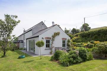 The cottage is surrounded by a lovingly maintained garden.