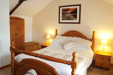The lovely double bedroom is a spacious and relaxing space.