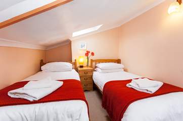 The twin bedroom has a sloped ceiling and is comfortably furnished (Bedroom 2).