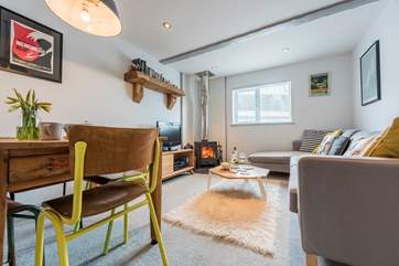 The sitting/dining-room has a little wood-burner.