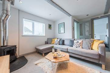 The corner sofa is great for relaxing in front of the wood-burner.