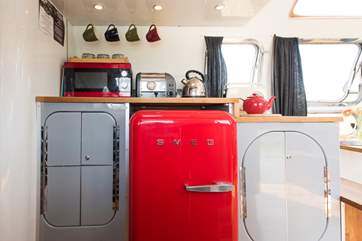 The kitchen has a quirky red Smeg fridge.
