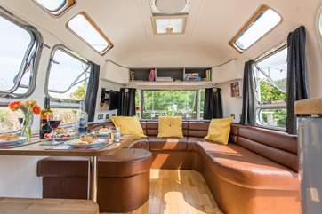 The comfy sitting-area, complete with TV, is at one end of the Airstream.