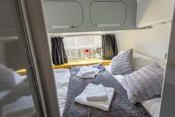The comfortable double bed is just past the bunk-beds and has a door to close it off from the rest of the Airstream.