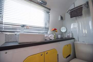 The compact shower-room has a proper flushing loo.