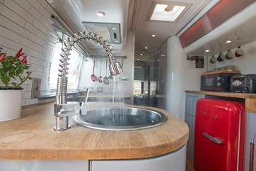 The kitchen sink also has hot and cold running water - who's turn is it to wash the dishes?