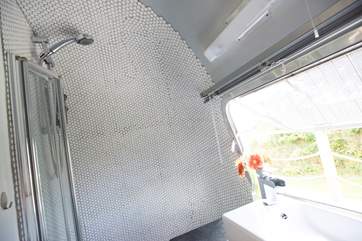 The shower-room is complete with hot and cold running water and flushing loo.