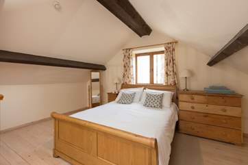 The mezzanine area is the bedroom, with this lovely king-size sleigh bed.
