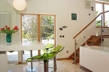 The kitchen has a big island unit and doors out to a decked balcony.