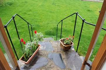 The steps from the sitting-room have a bespoke cast iron handrail made by a local craftsman.