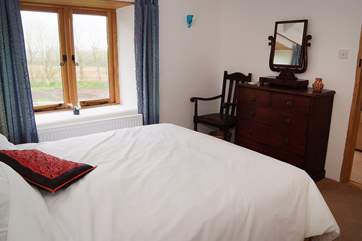 The cottage is furnished with a combination of antique and modern furniture.