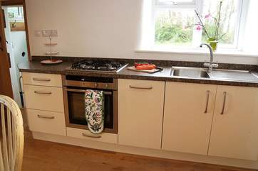 The modern and very well-equipped kitchen with garden views.
