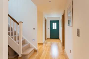 The wide entrance hallway flows seamlessly into the living-room.