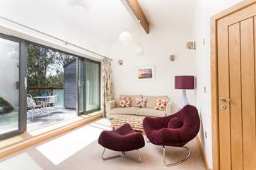 The first floor sitting area has doors out to the balcony.