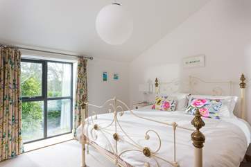 Bedroom 2 on the first floor has a huge supe-rking bedstead.