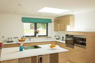 The fully equipped kitchen-area even has a wine fridge to keep the bubbly chilled!