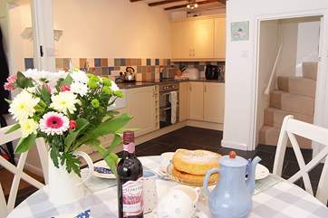 The kitchen/dining-room is a lovely cheerful room. Thoughtful touches include a coffee machine.