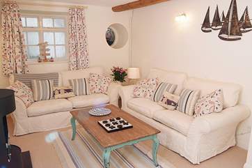 The sitting-room is very cosy, with two sofas and a happy seaside theme.