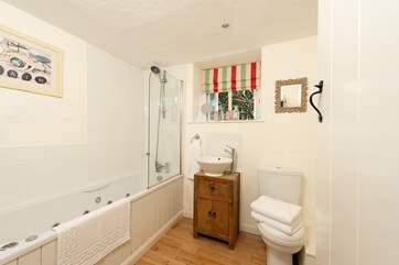 This is the en-suite bathroom offers a bath as well as a fitted shower.