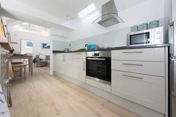 The kitchen leads to the living-area.