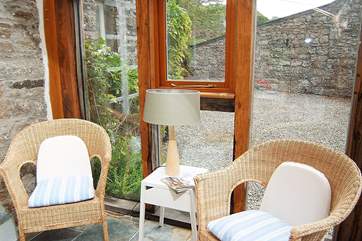 A corner of the conservatory where you can sit and relax with the paper or a book.