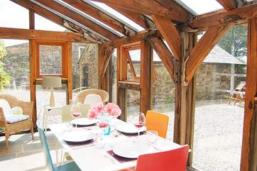 The conservatory looks out over the gravelled courtyard and garden beyond.