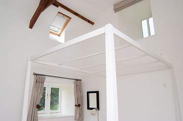 The bedroom also has a high ceiling.