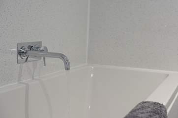 There's a large bath in the en suite bathroom.